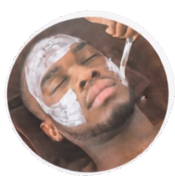 Gentleman reclined in the lounge chair during a hot towel spa facial, cleansing mask on