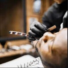 Hot towel laid over a client's face during a shave